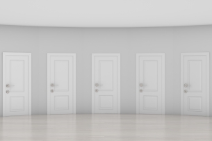 Pale gray hall with five white doors that look exactly the same