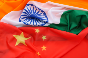 The flags of China and India, unfurled next to one another.