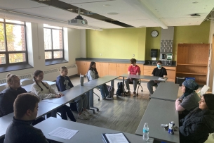 A group of Le Moyne students sit at desks