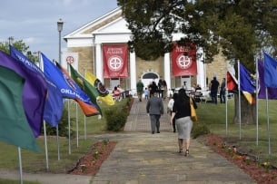 A photo of people walking on Bacone College's campus.
