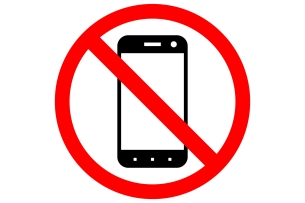A sign prohibiting smartphone usage, featuring a black-and-white drawing of a smartphone inside a red circle with a diagonal slash through it.