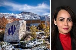 The Weber State University W logo is painted on a rock in purple, displayed in front of a snowy campus
