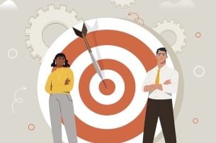 Black woman and white man with arms crossed stand in front of an arrow in a bull's-eye