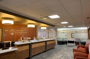 A photo of a lobby with multiple chairs and a long counter. The wall reads: "Counseling and Psychological Services, Florida State University."