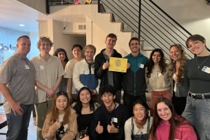 Students and alumni smile for a photo after a UCLA dinner.