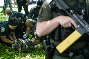 A photo of a protestor being arrested at Emory University.