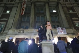 Protesters stand in front of a building they’ve occupied at Columbia University
