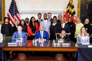 A photo of Maryland politicians, alongside Cameron Carden and his mother, Gay Green-Carden,at the signing of the Cameron Carden Act.