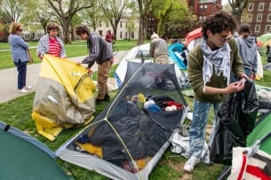 A photo of student protesters dismantling an encampment at Brown University.