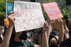 A photo of pro-Palestinian protesters holding signs.