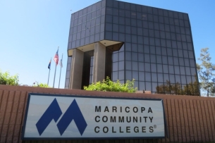 A sign reads “Maricopa Community Colleges” in front of an administrative building.