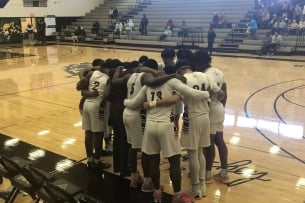 The South Arkansas College men’s basketball team huddles before a game.