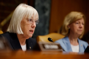 Senator Patty Murray sits behind a microphone
