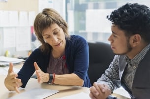 Counseling appointment for young Latino student in an office.