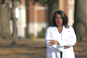 A photograph of Kimberly Diei in a white coat.