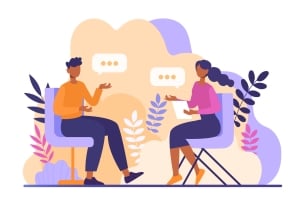 A purple- and orange-hued illustration of two colleagues sitting in desk chairs talking amicably with each other.