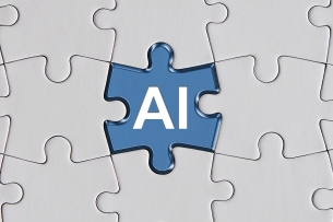 A blue jigsaw puzzle piece with the letters "AI" sits in the center of a puzzle; all the other pieces are white and blank.
