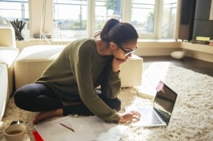 Young woman studying and working on her laptop