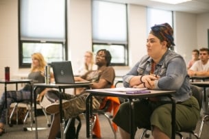 Students sit at desks in an Erie County Community College classroom.