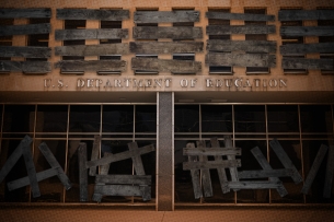 A photo illustration of a boarded-up Department of Education building
