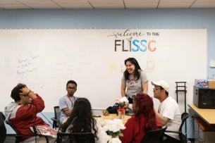 A group of students sit and chat in a circle at Stanford University's center for first-generation, low-income students
