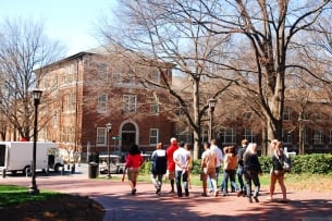In this photograph taken from some distance away, prospective students and their families can be seen taking a campus tour at the Georgia Institute of Technology.