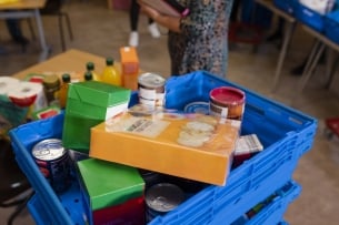 Close up of a crate filled with various foods at a food bank being set up in a community church in the northeast of England.
