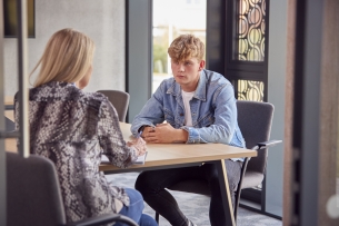 College student having individual meeting with tutor