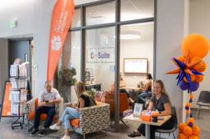 Students smile and chat outside the Clemson University C-Suite career development hub