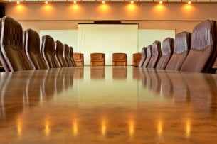 A photo of an empty boardroom table.