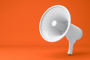A 3-D rendering of a white megaphone against an orange background.