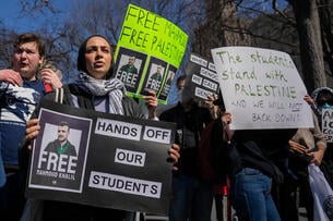 Demonstrators hold signs with photos of Mahmoud Khalil that say "Free Mahmoud, free Palestine"