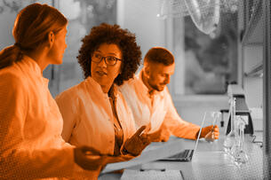 Photo illustration of scientists reviewing documents