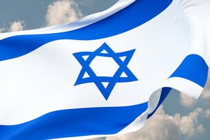 A close-up of a waving Israeli flag.