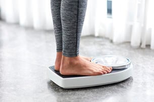 Young girl on home scale