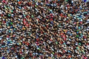 A photo of a large crowd of people gathered in one place, taken from overhead with a drone.