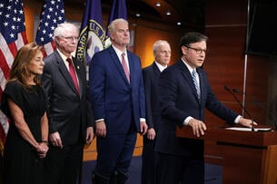 U.S. Speaker of the House Mike Johnson flanked by other congressional Republicans speaks at a podium.
