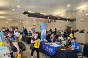 Students walk through a career fair in a conference center space