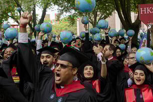Students with caps and gowns and globes