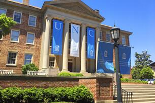 A building at UNC decorated with Tar Heel blue and white banners