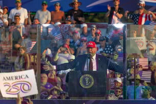 President Donald Trump spreads out his arms at a rally 