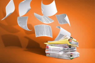 Paperwork blowing off a pile. 