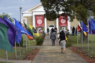 A photo of people walking on Bacone College's campus.