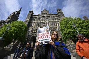 Protesters at Georgetown hold a "Ceasefire Now" sign