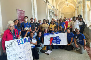 A group of AFT Local 2026 members hold up signs. 