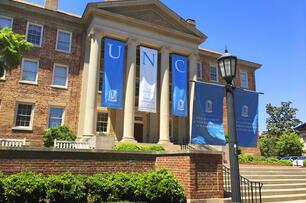 A building at UNC decorated with Tar Heel blue and white banners