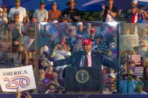 President Donald Trump spreads out his arms at a rally 