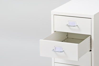 An open drawer in a filing cabinet.