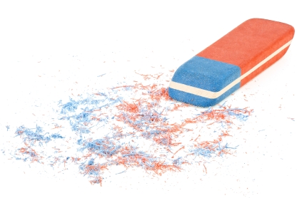 blue and orange eraser with shavings as if something has been rubbed out, like a letter or two