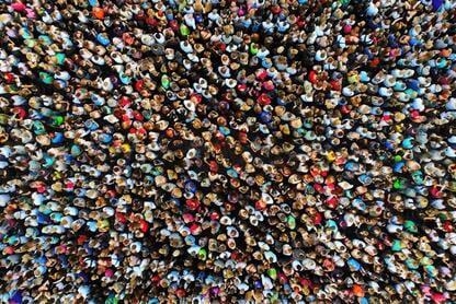 A photo of a large crowd of people gathered in one place, taken from overhead with a drone.
